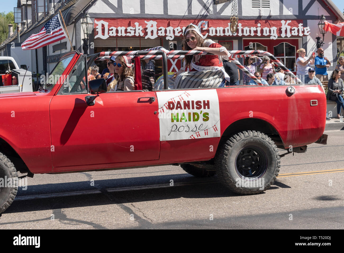 Red truck in parade with sign "Danish Maid's"; Danish days street