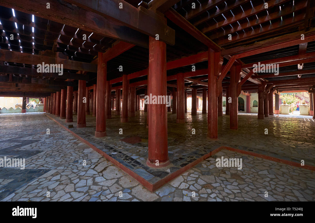 The red column supports underneath the teak wood raised Shwe In Bin Monastery in Mandalay, Myanmar. Stock Photo