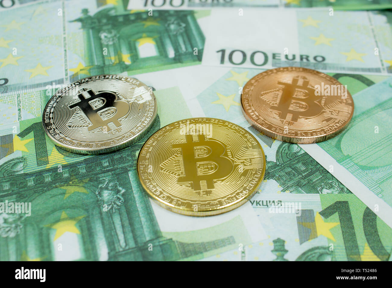 Close-up of 3 Bitcoin coins on 100 Euro banknotes. Crypto currency BTC  Stock Photo - Alamy