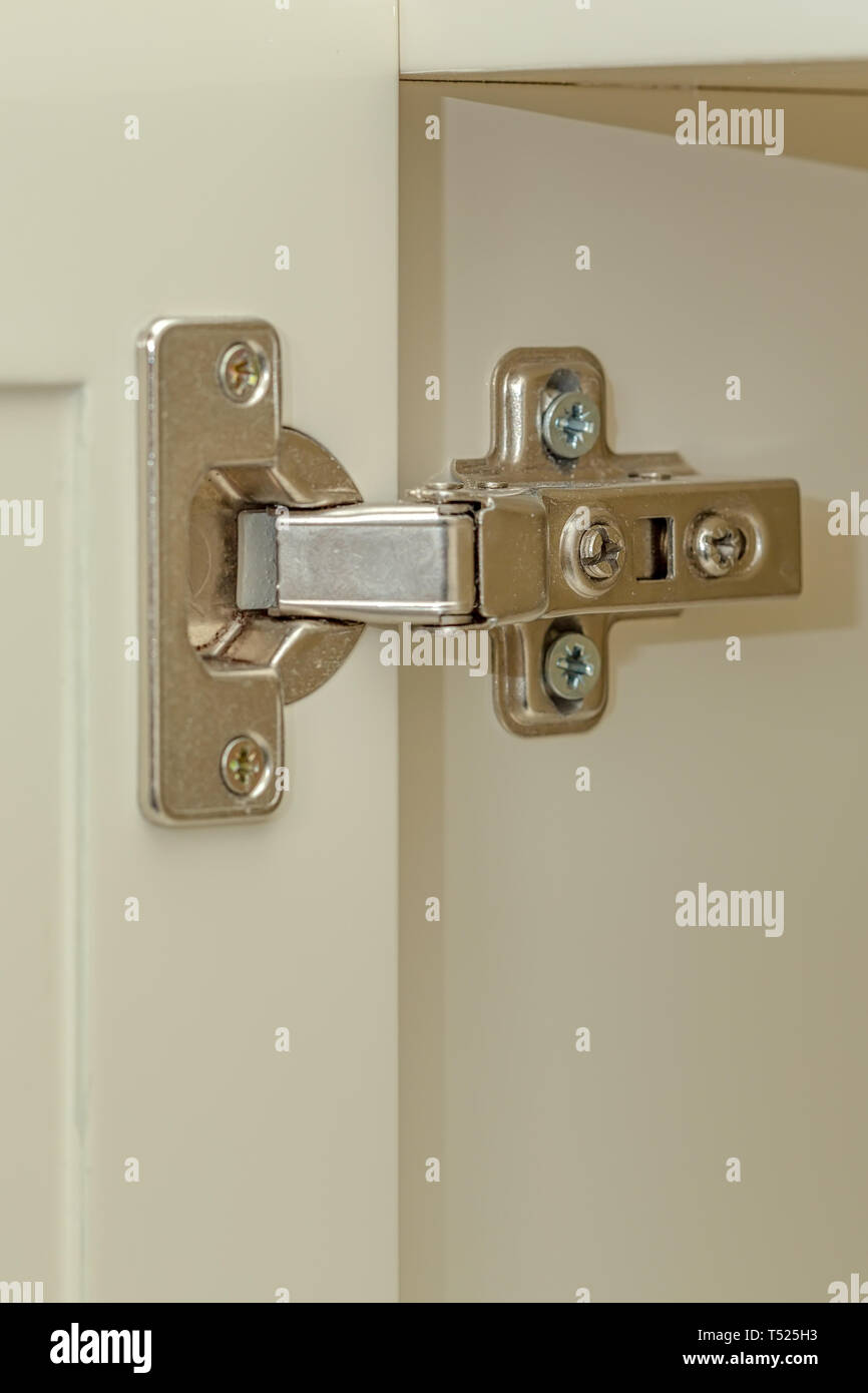 Standard professional hinge for overlay for all kinds of furniture. Hinge assembled on white