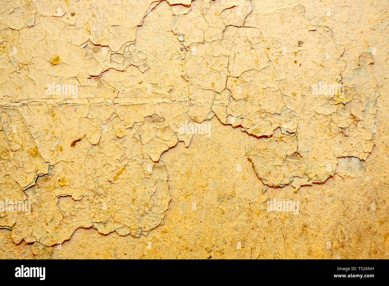 Peeling beige  paint on the wall Stock Photo