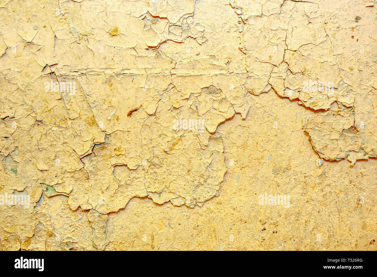 Peeling beige  paint on the wall Stock Photo