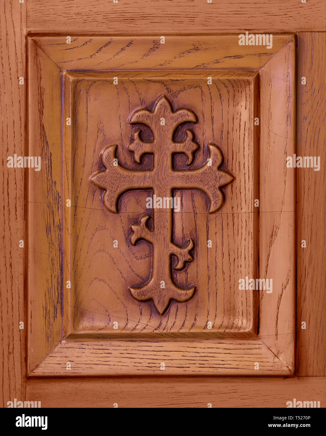 Christian cross etched in wooden panel Stock Photo