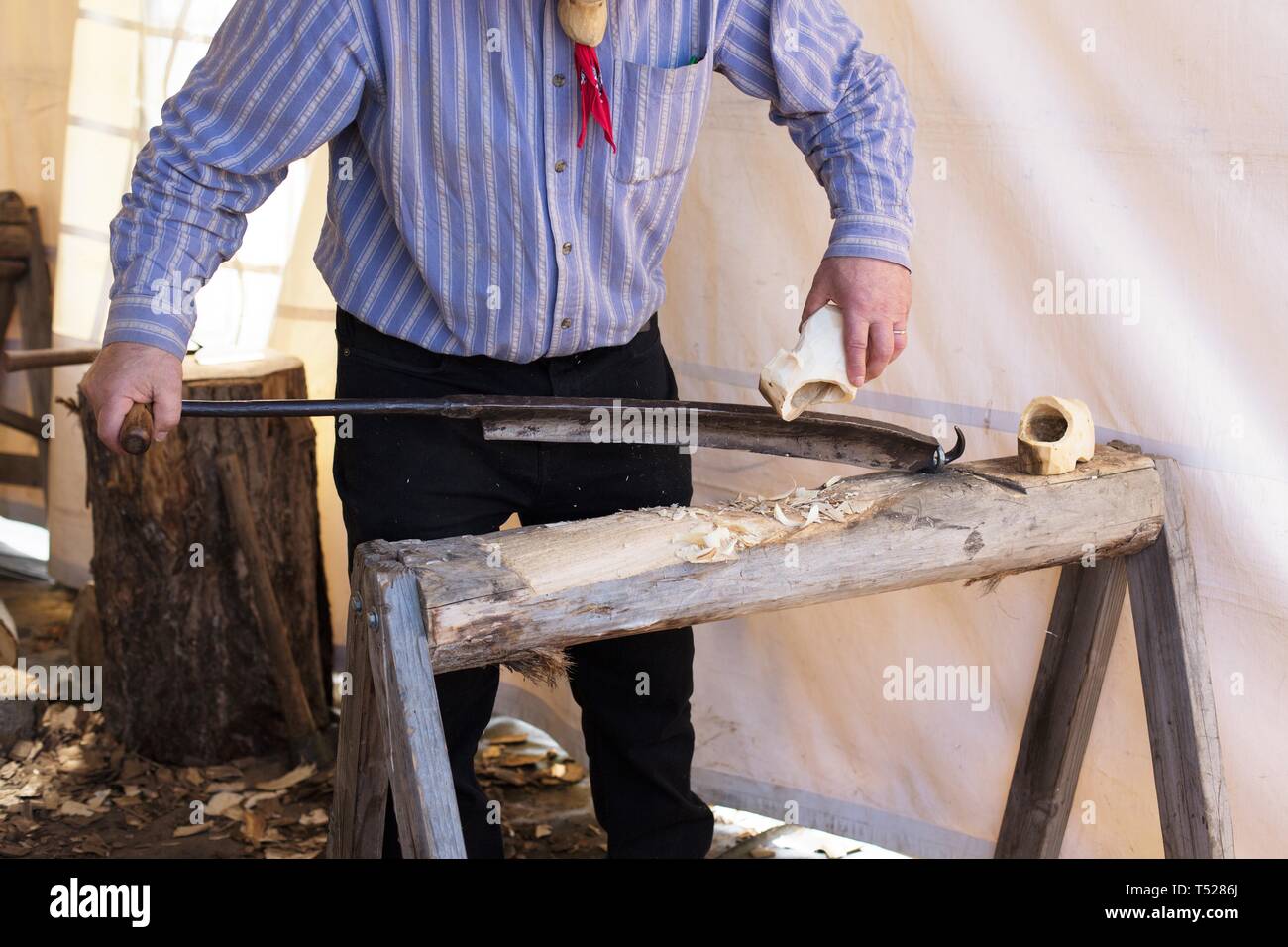 A shoe maker making dutch wooden shoes at the Wooden Shoe Tulip Festival in Woodburn, Oregon, USA. Stock Photo