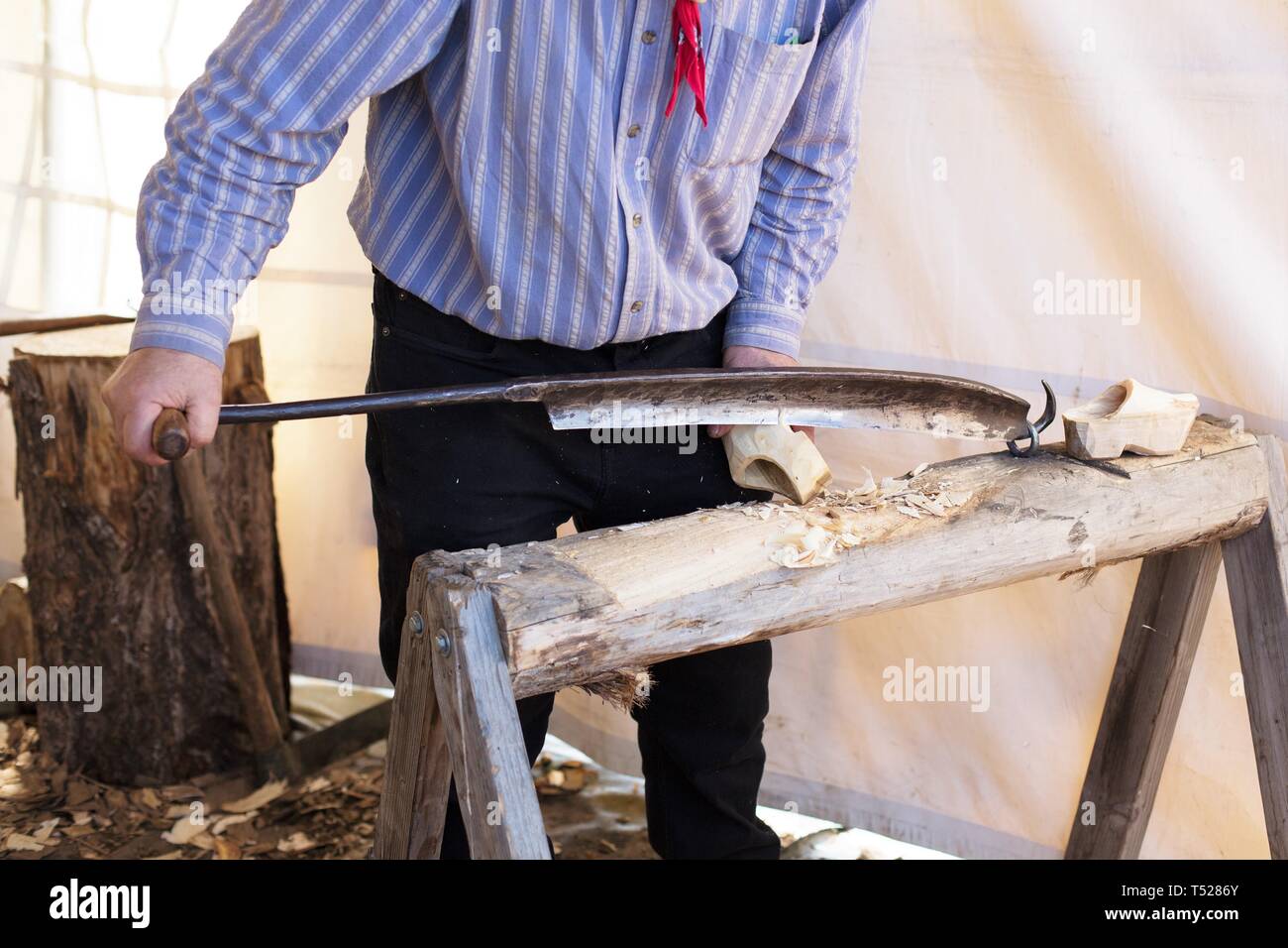 A shoe maker making dutch wooden shoes at the Wooden Shoe Tulip
