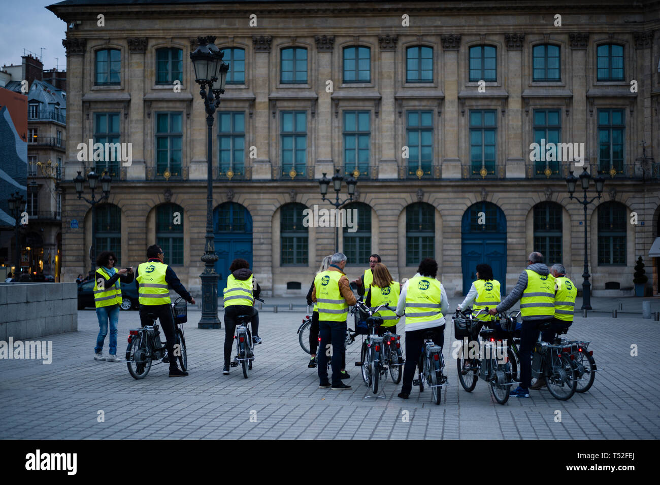 Yellow vests on bicycles, Paris France Stock Photo