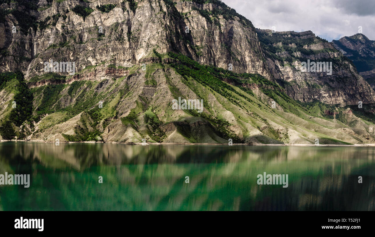 Mountains and transparent lake against a cloudy sky. Gunib district of Dagestan Stock Photo