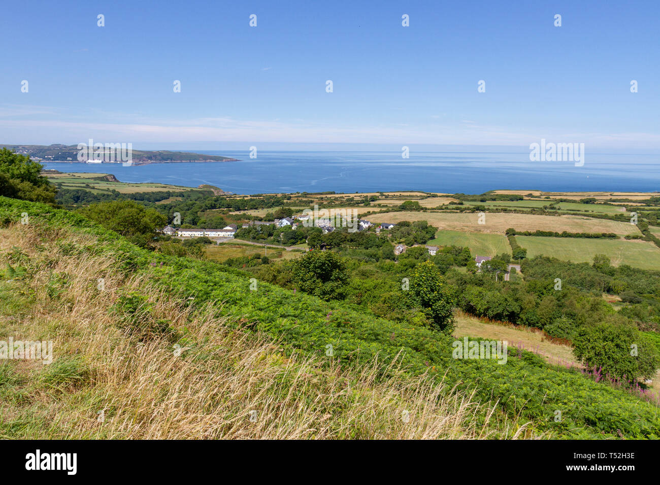 Stunning view over fields near Newport, Pembrokeshire Coast National Park, Wales towards Fishguard harbour and the Irish Sea. Stock Photo