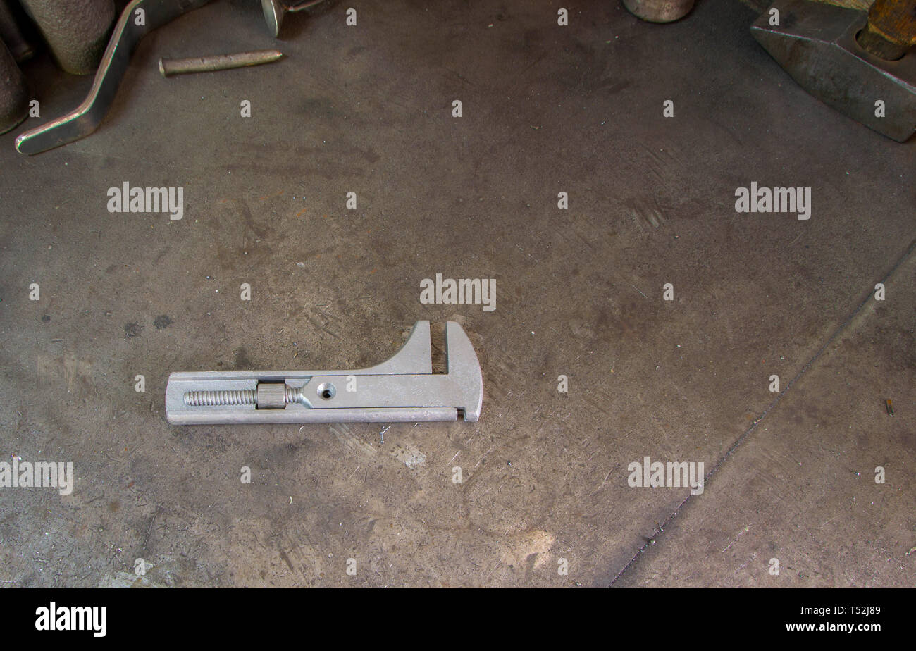 Restored and painted an antique monkey wrench on a metal background