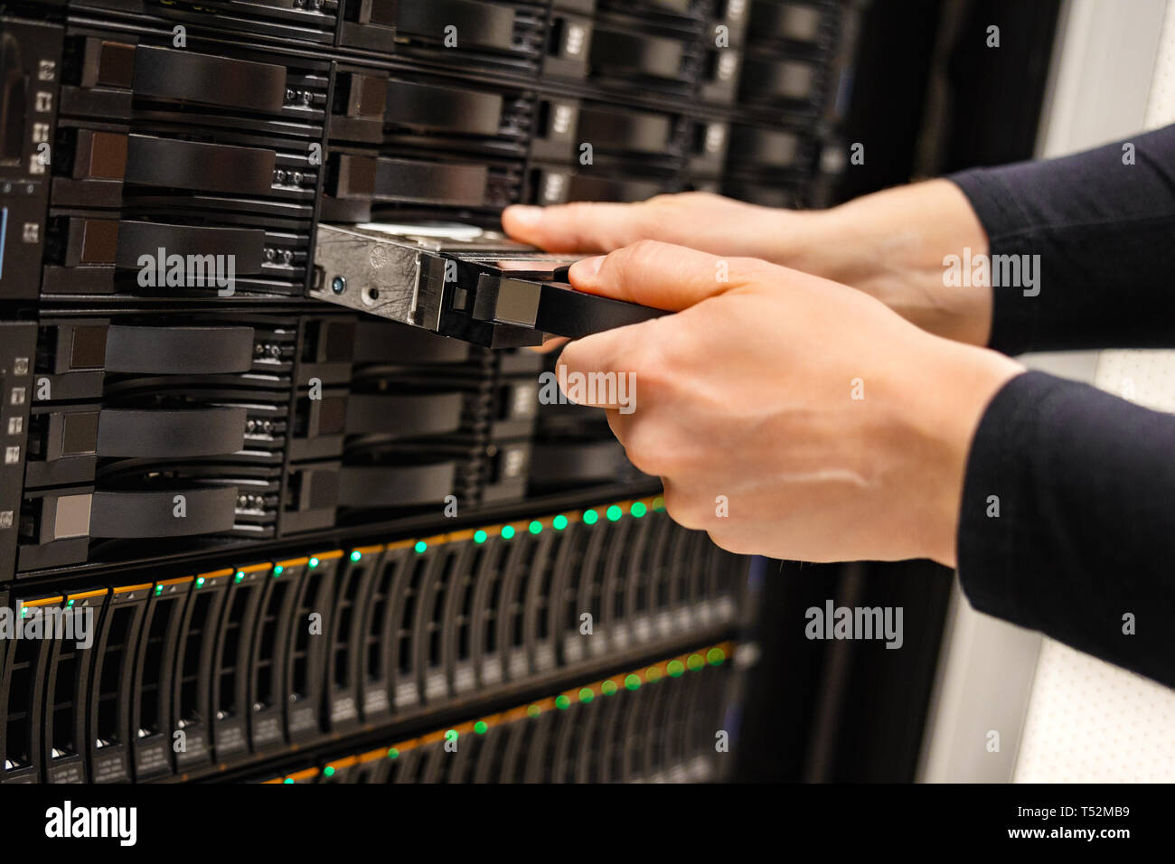 Male IT Technician Replacing Server Drive In San Stock Photo