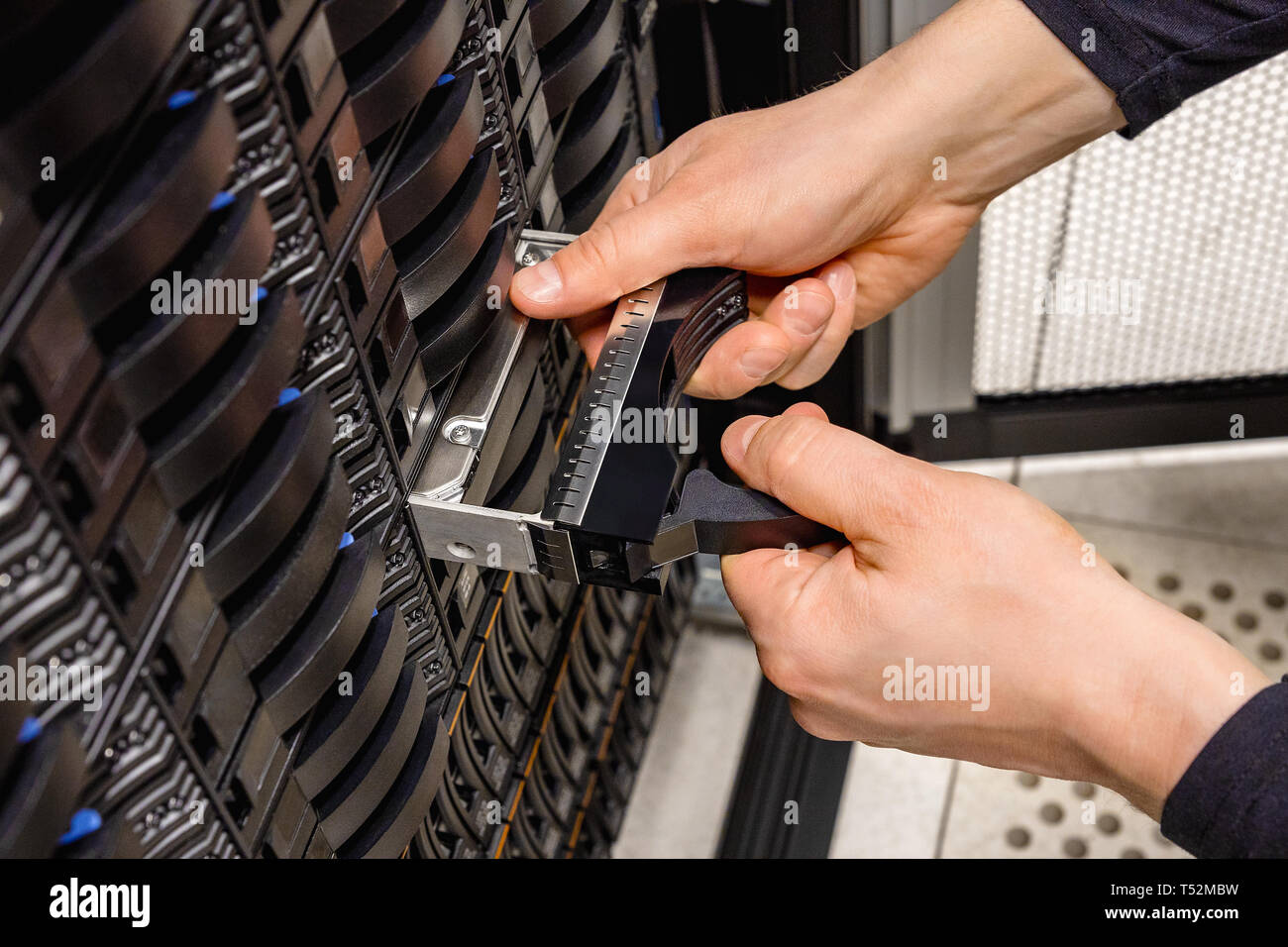 IT Professional Replacing Hard Disk In San At Datacenter Stock Photo