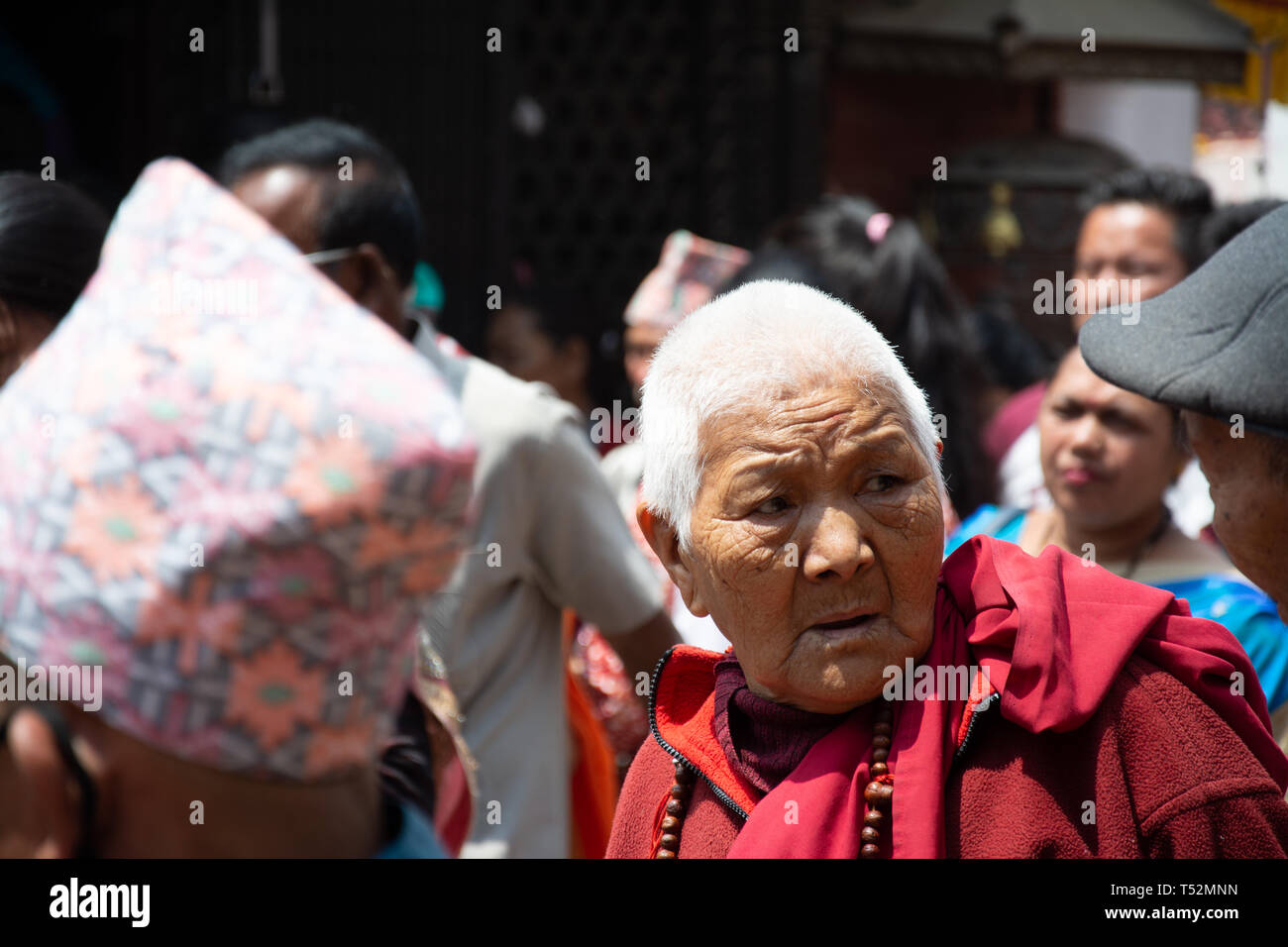 Kathmandu, Nepal - May 10, 2017: An old lama priest at the premises of the Bouddha stupa. Stock Photo
