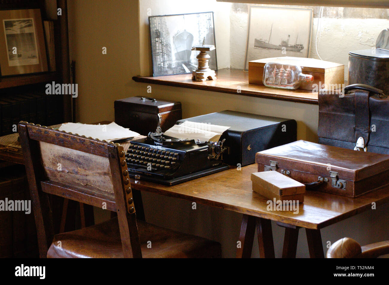 Author's working place. Antique desk with writer's utensils. Typewriter. Stock Photo