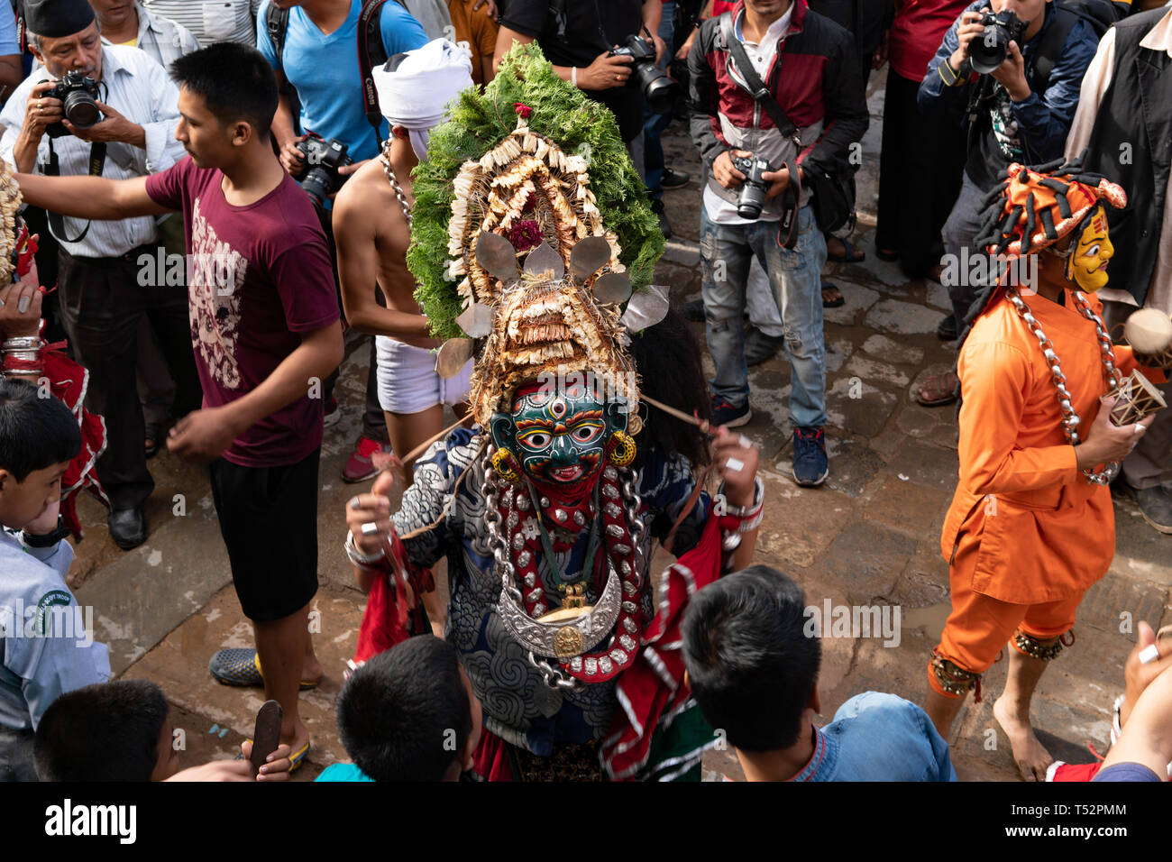 Kathmandu, Nepal - September 03, 2017: Traditional masked dance performance prior to erecting a huge tree trunk in front of the Hanumandhoka Palace. Stock Photo