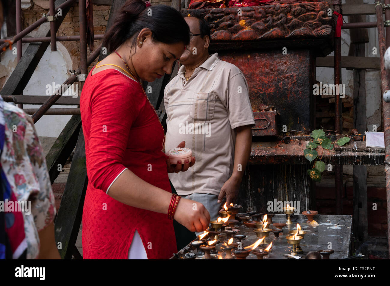 Kathmandu, Nepal September 03, 2017 Mature lady lighting the ghee