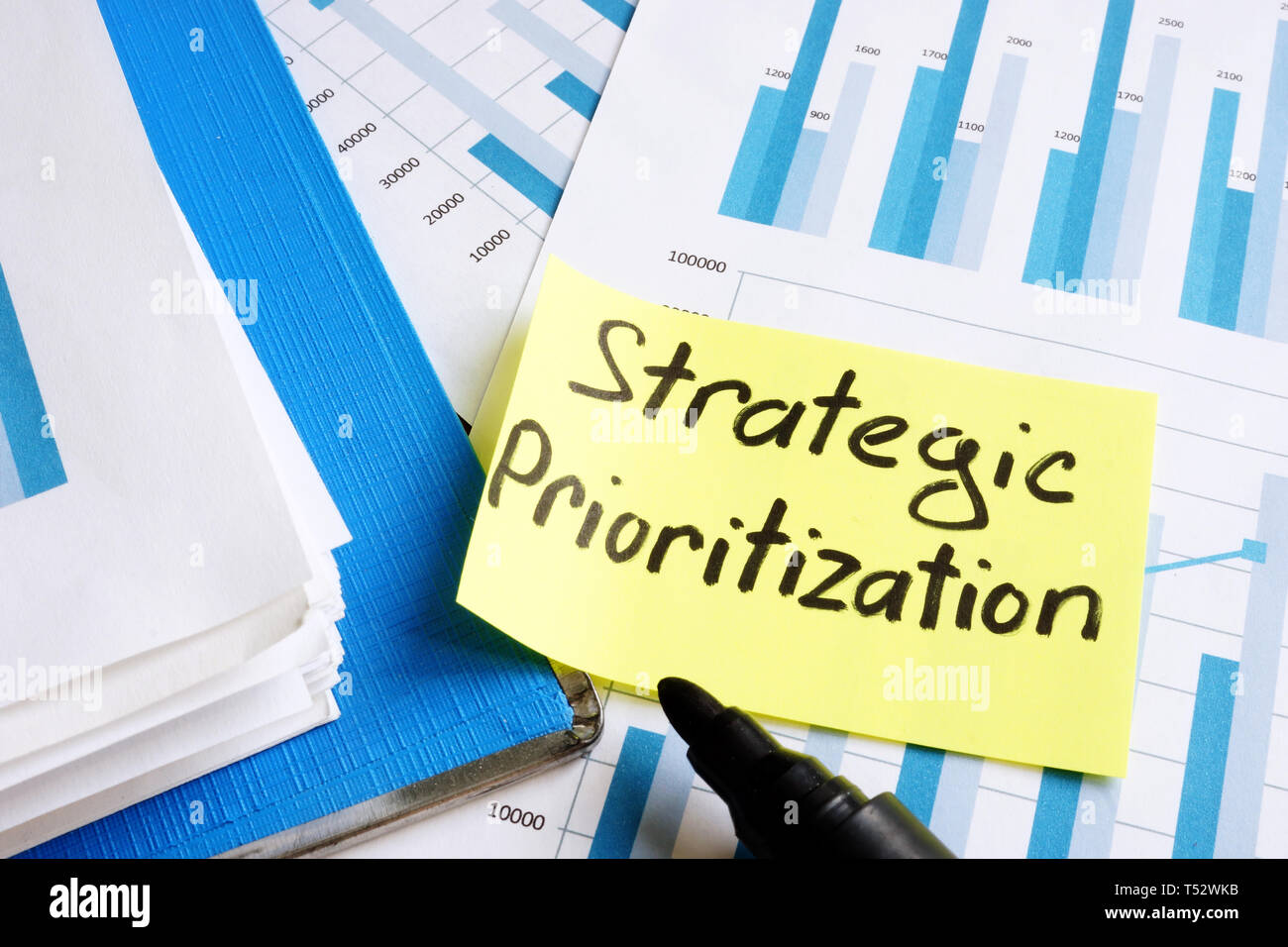 Strategic Prioritization concept. Documents and folder with papers. Stock Photo