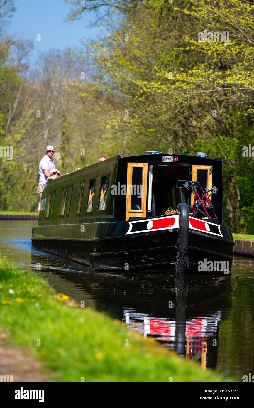 Front view of a canal boat travelling towards the camera with people on board, Pontcysyllte near Llangollen, Wales, UK. Stock Photo