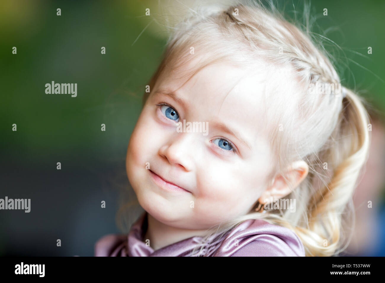 A girl of 4-5 years old with white hair is a large portrait on a clear  sunny day, an unrealistically beautiful child Stock Photo - Alamy