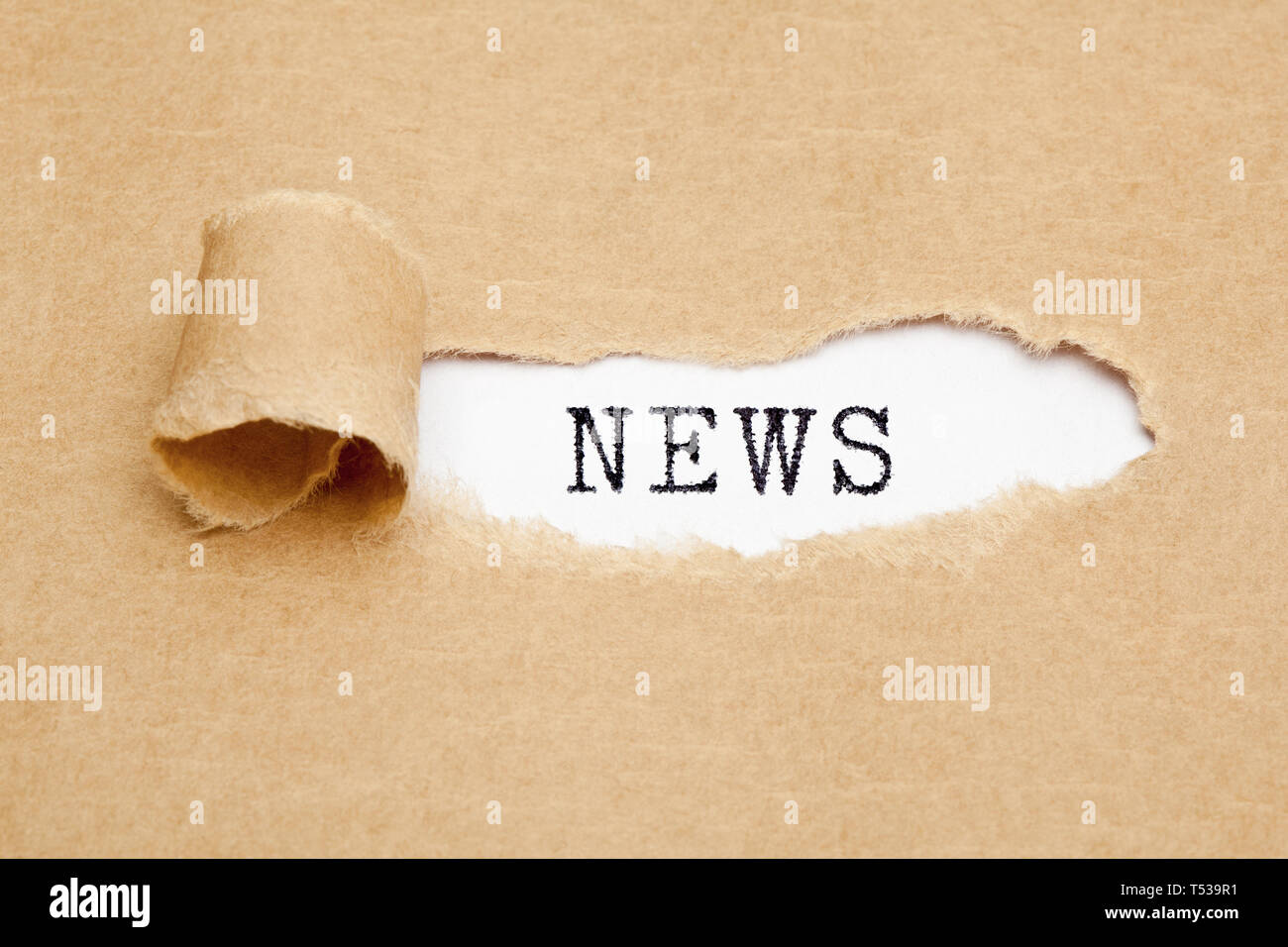 Word News appearing behind ripped brown paper. Media press information concept. Stock Photo