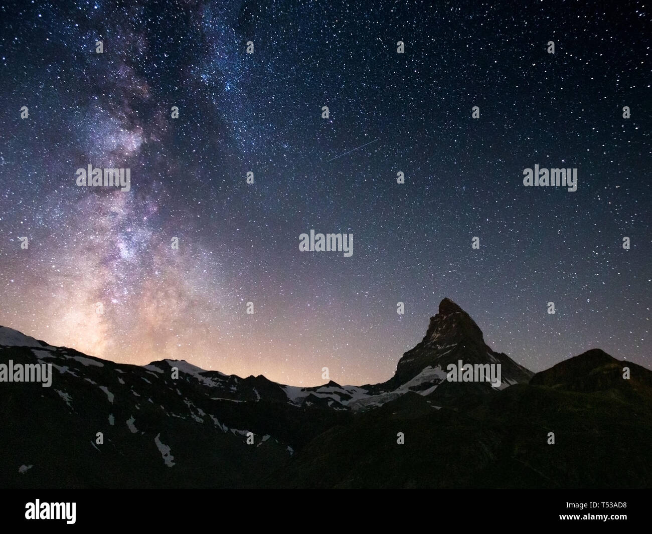 Starry sky, Milky Way. Night landscape. Matterhorn mountain massif (Cervino). Swiss Alps. Switzerland. Europe. Stock Photo
