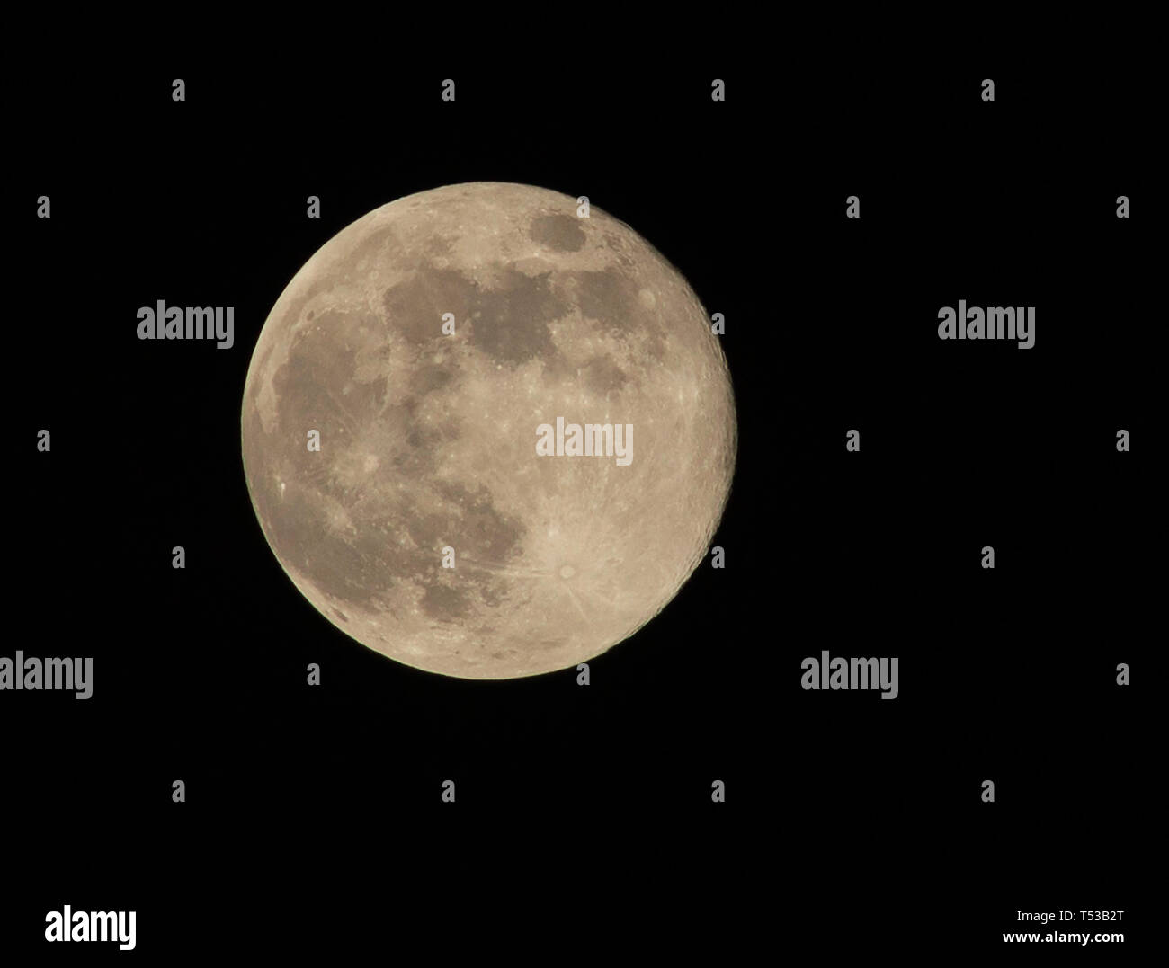 Near full moon 99.4% (waning gibbous) April 19 2019 showing the detail of the moons surface Stock Photo