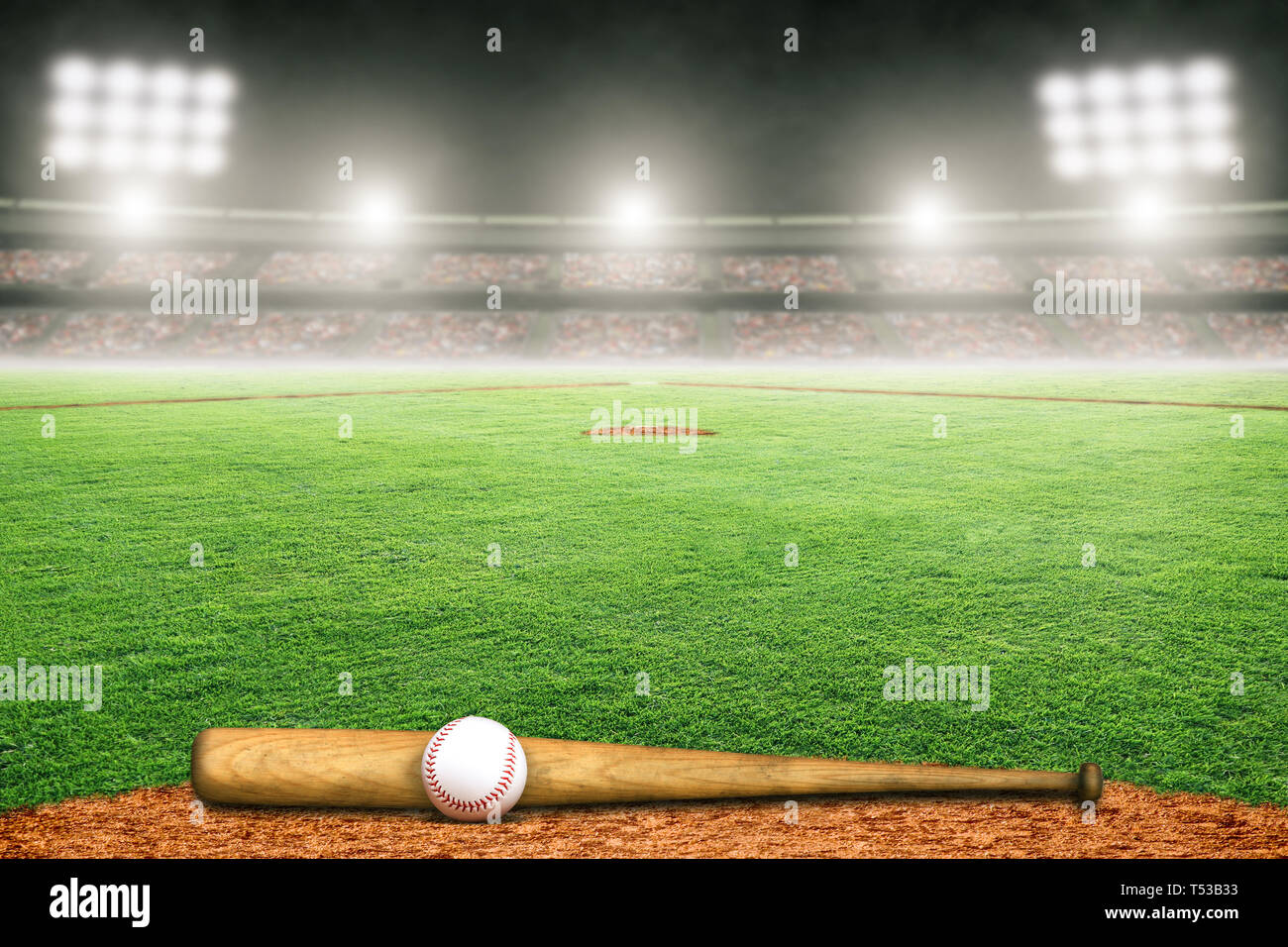 Baseball bat and ball on field at brightly lit outdoor stadium. Focus on foreground and shallow depth of field on background and copy space. Stock Photo