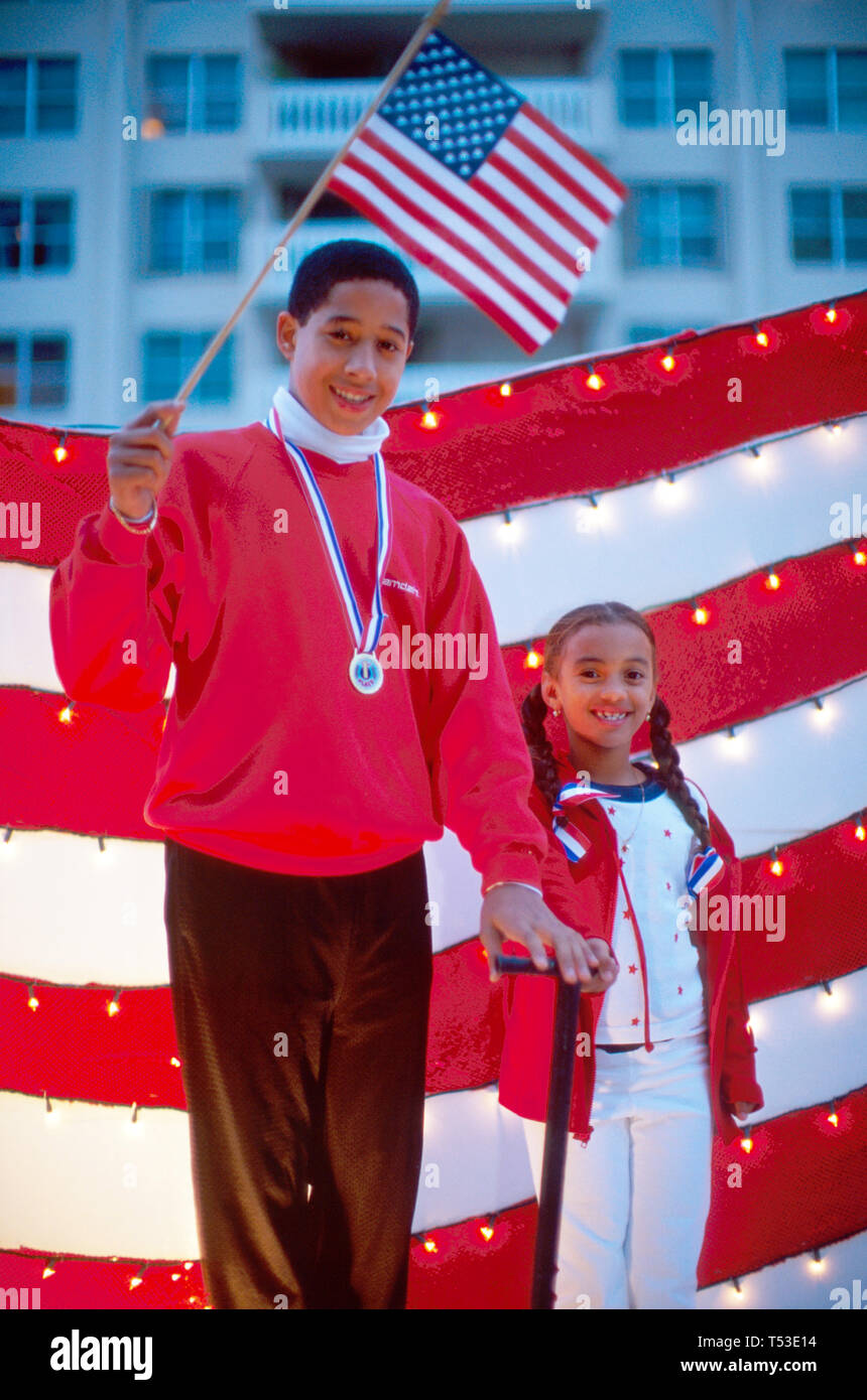 Florida Coral Gables Junior Orange Bowl Parade,Hispanic Latin Latino ethnic immigrant immigrants minority,kids,child,children,on float US flag,visitor Stock Photo