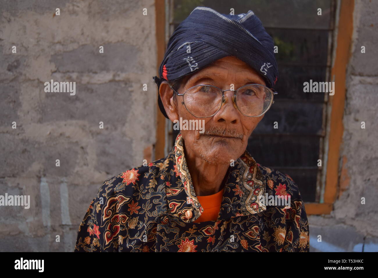 parents using typical Javanese clothes, also blangkon like hats, traditional Javanese traditional clothing called batik Stock Photo