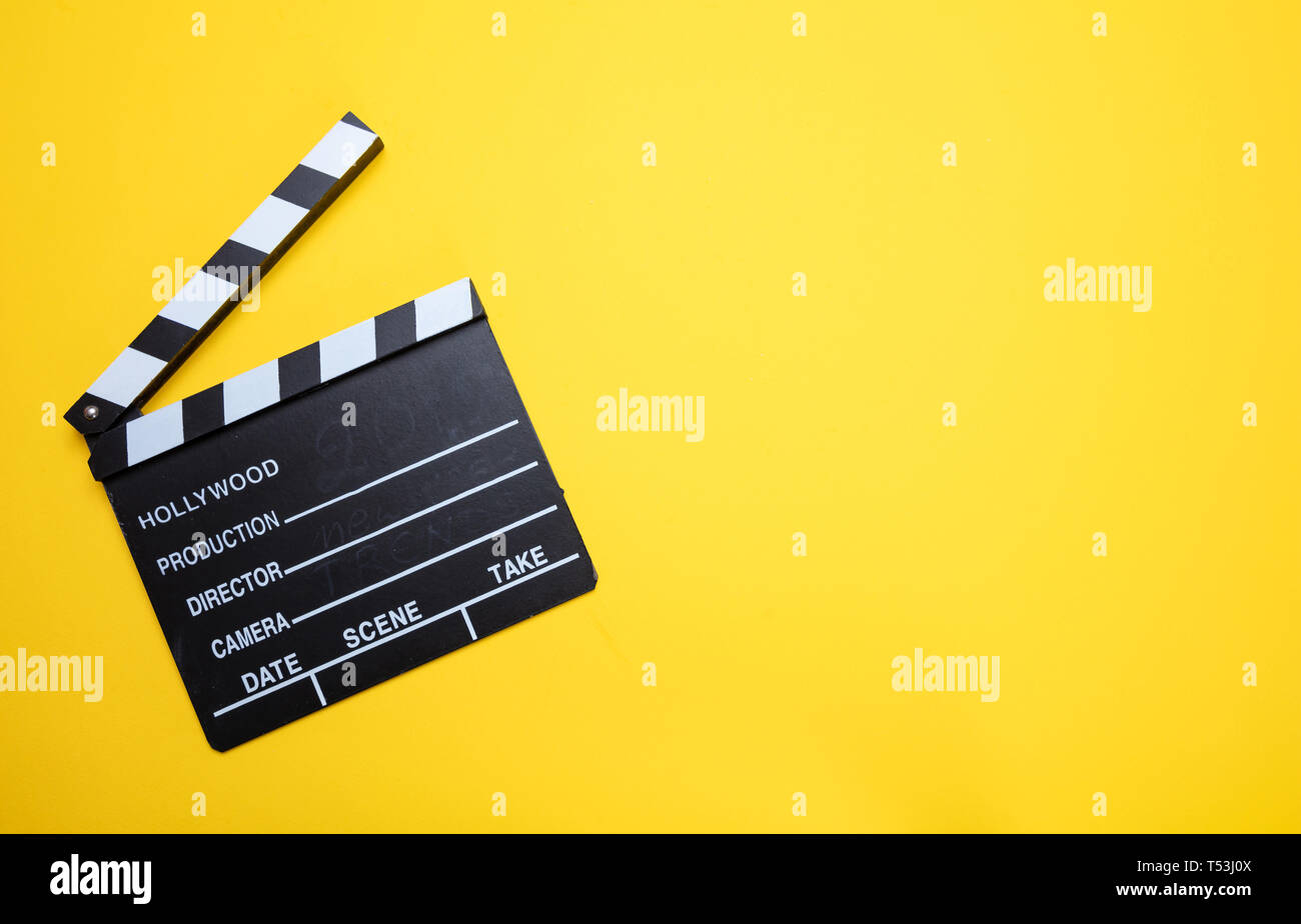 Cinama film concept. Movie clapper board on yellow color background, copy space Stock Photo