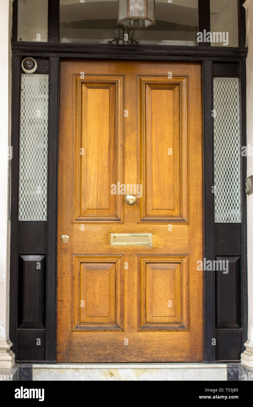 Wooden Entrance Door to residential building in London. Typical door in the English style. Stock Photo