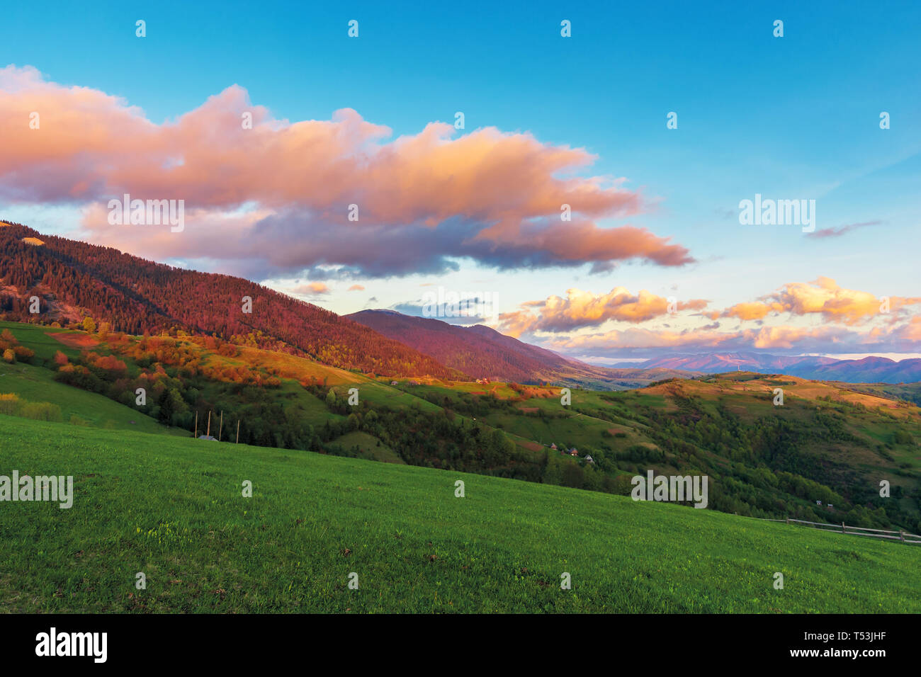 beautiful rural landscape in mountains at dawn. agricultural fields on hills. ridge in the distance. wonderful european countryside in springtime. gor Stock Photo