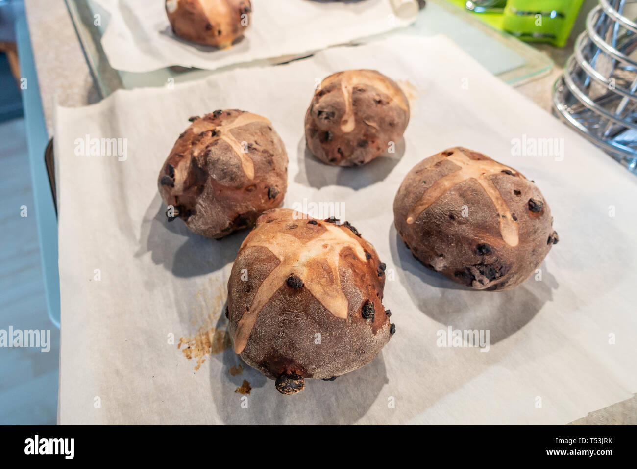 Home made hot cross buns on a baking sheet. Stock Photo