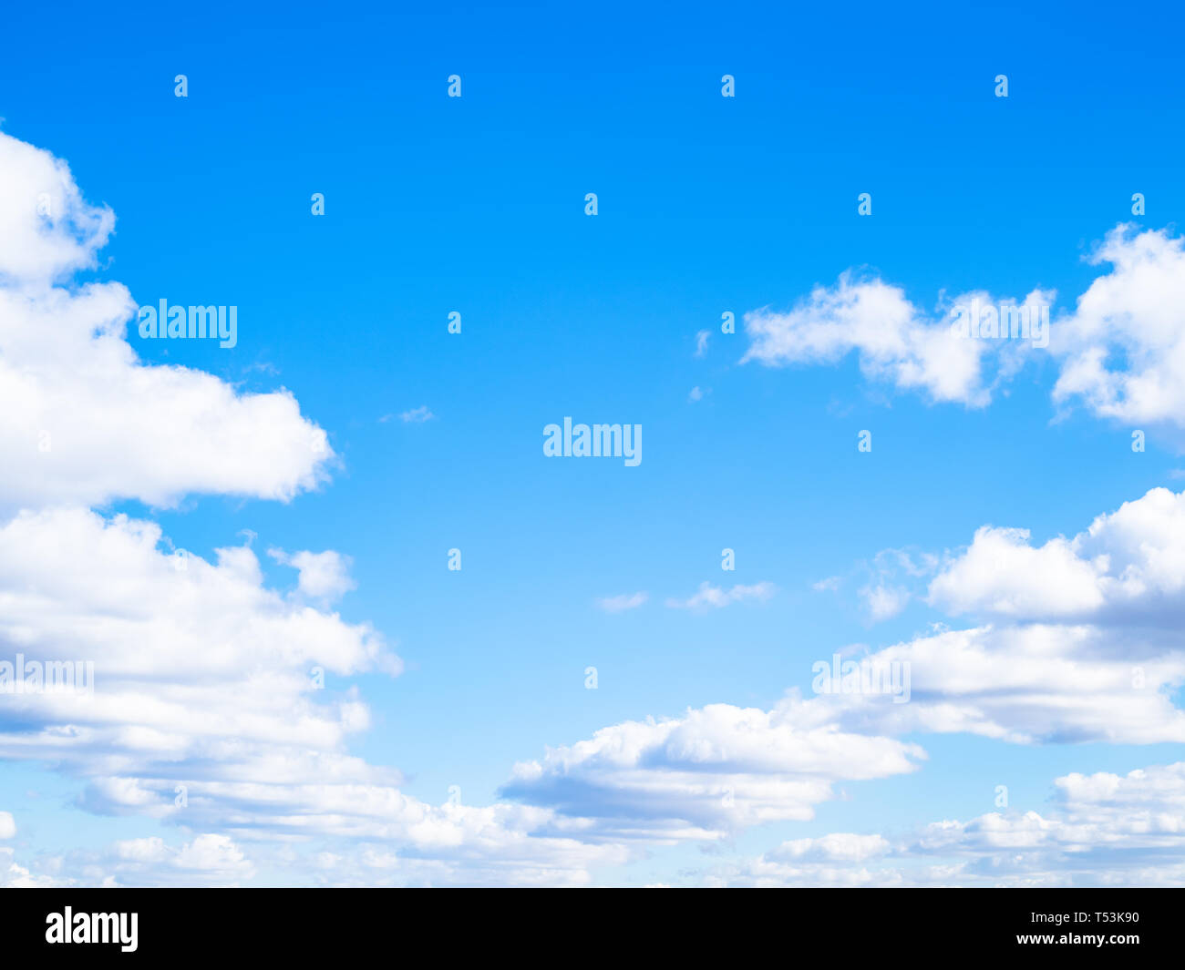 wedge of white clouds in blue sky in sunny spring day Stock Photo
