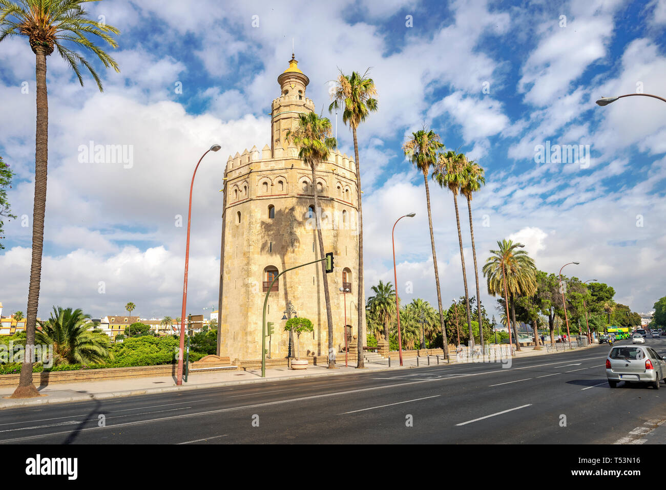 Cityscape with street along  Guadalquivir river and Torre del Oro (gold tower) in Seville. Andalucia, Spain Stock Photo