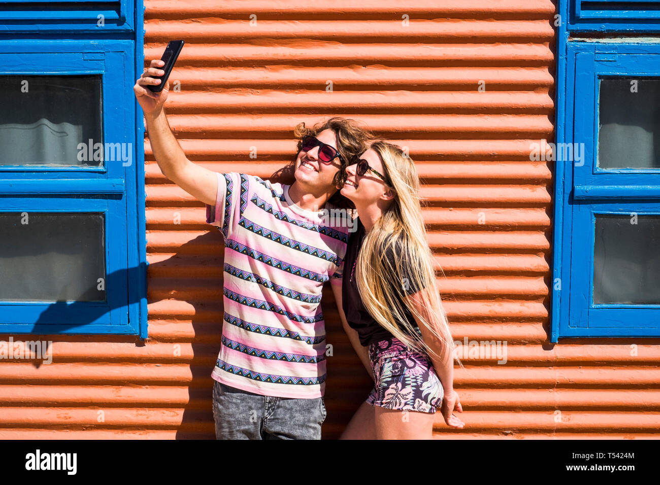 Young beautiful millennial caucasian couple of people man and woman taking selfie picture together in relationship for summer holiday - happiness and  Stock Photo