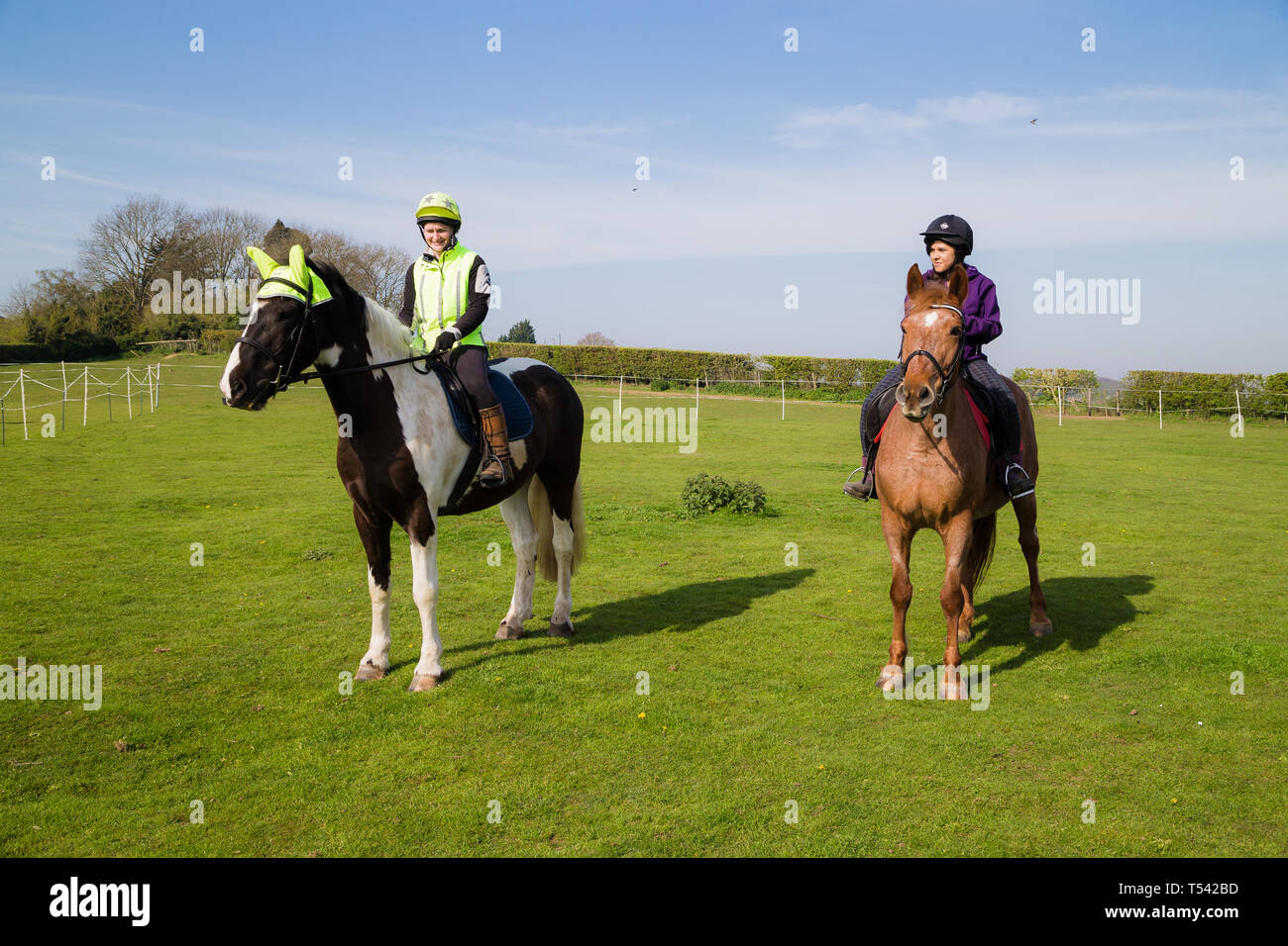 Kent. UK. Two horse riders going for a hack in the countryside on a lovely sunny day. Stock Photo