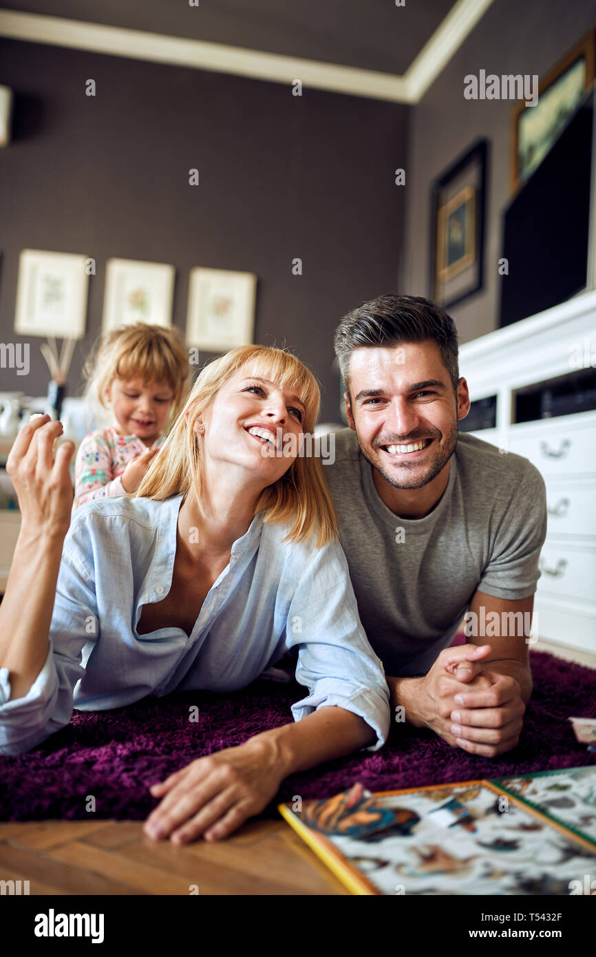 Happy mom and dad happy together with female cute child Stock Photo - Alamy