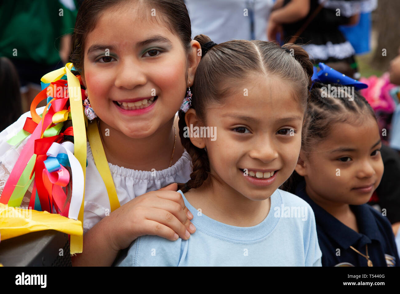 Two young Hispanic girls smiling and posing at the Cinco de Mayo Parade. St Paul Minnesota MN USA Stock Photo