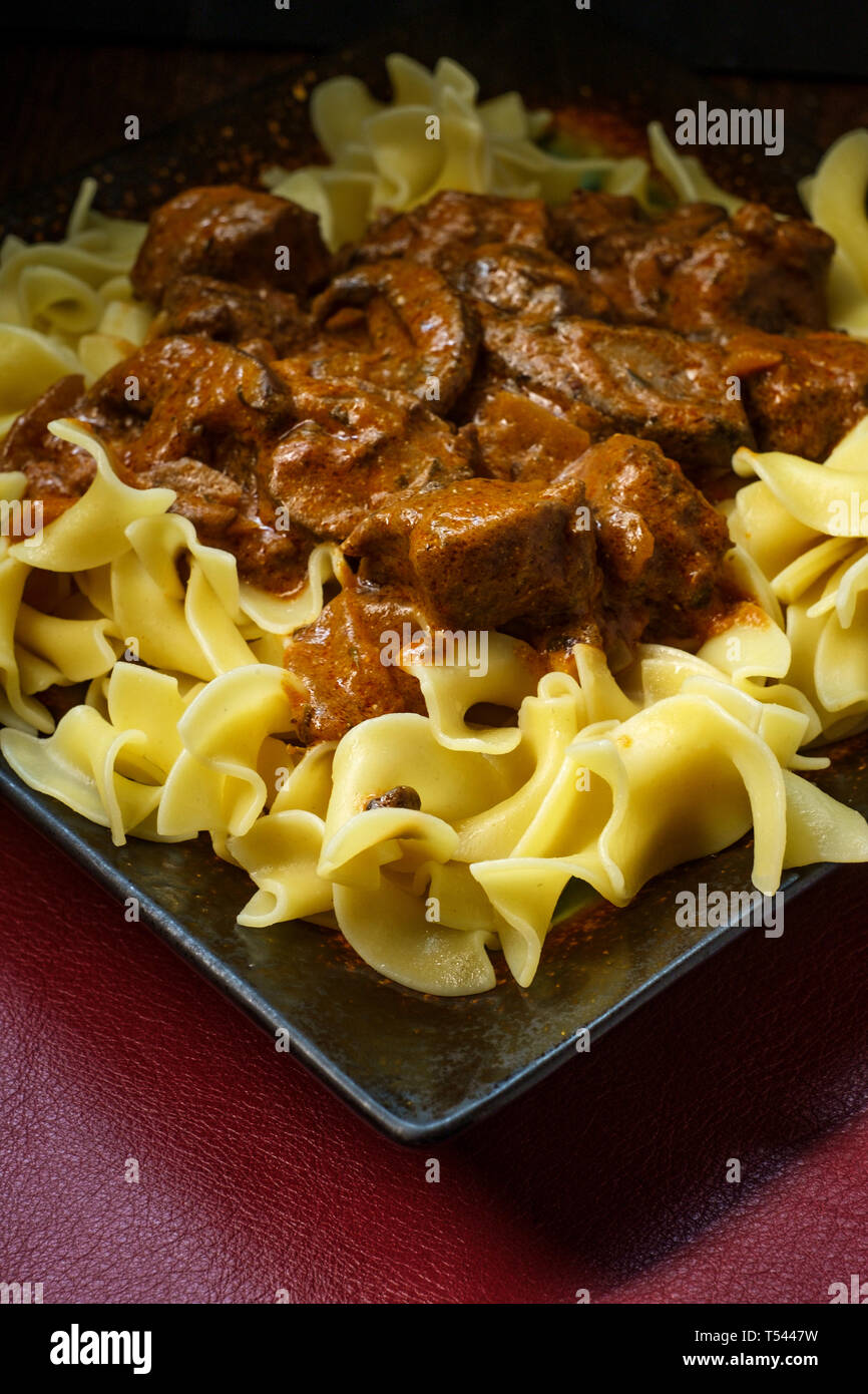 Hearty beef and mushroom stroganoff with egg noodles Stock Photo - Alamy