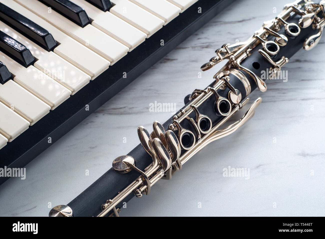 Rusty old classical clarinet on marble table next to electric piano  keyboard Stock Photo - Alamy