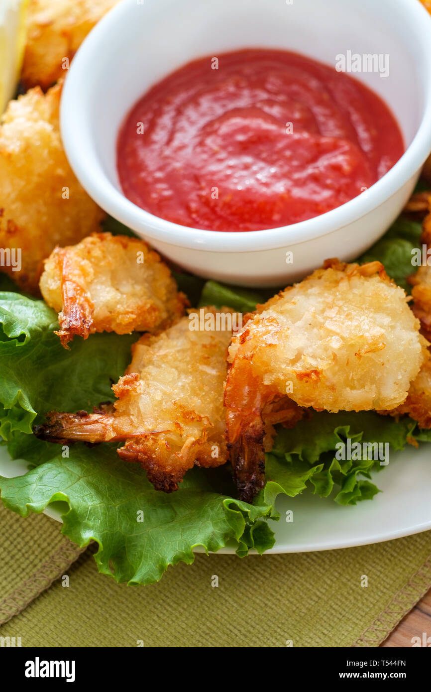Breaded and fried butterfly coconut shrimp served on bed of romaine