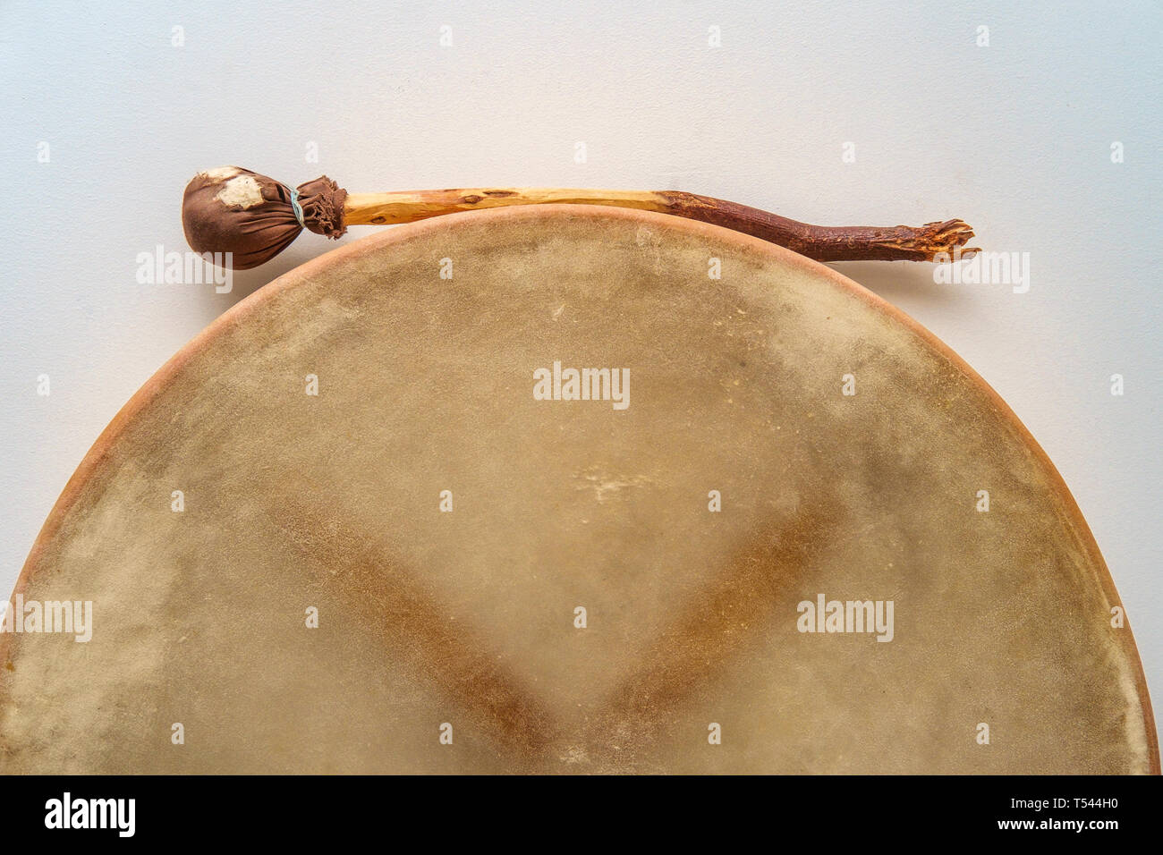 Traditional Irish bodhran drum hung on wall with tipper Stock Photo Alamy