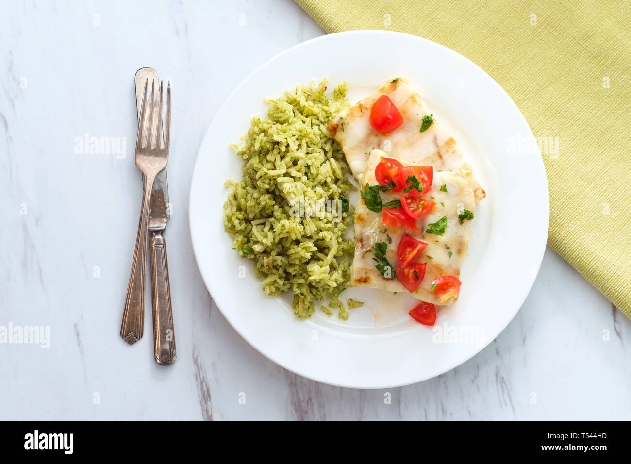Grilled Alaskan Pollock fish fillets with lemon butter and green rice ...