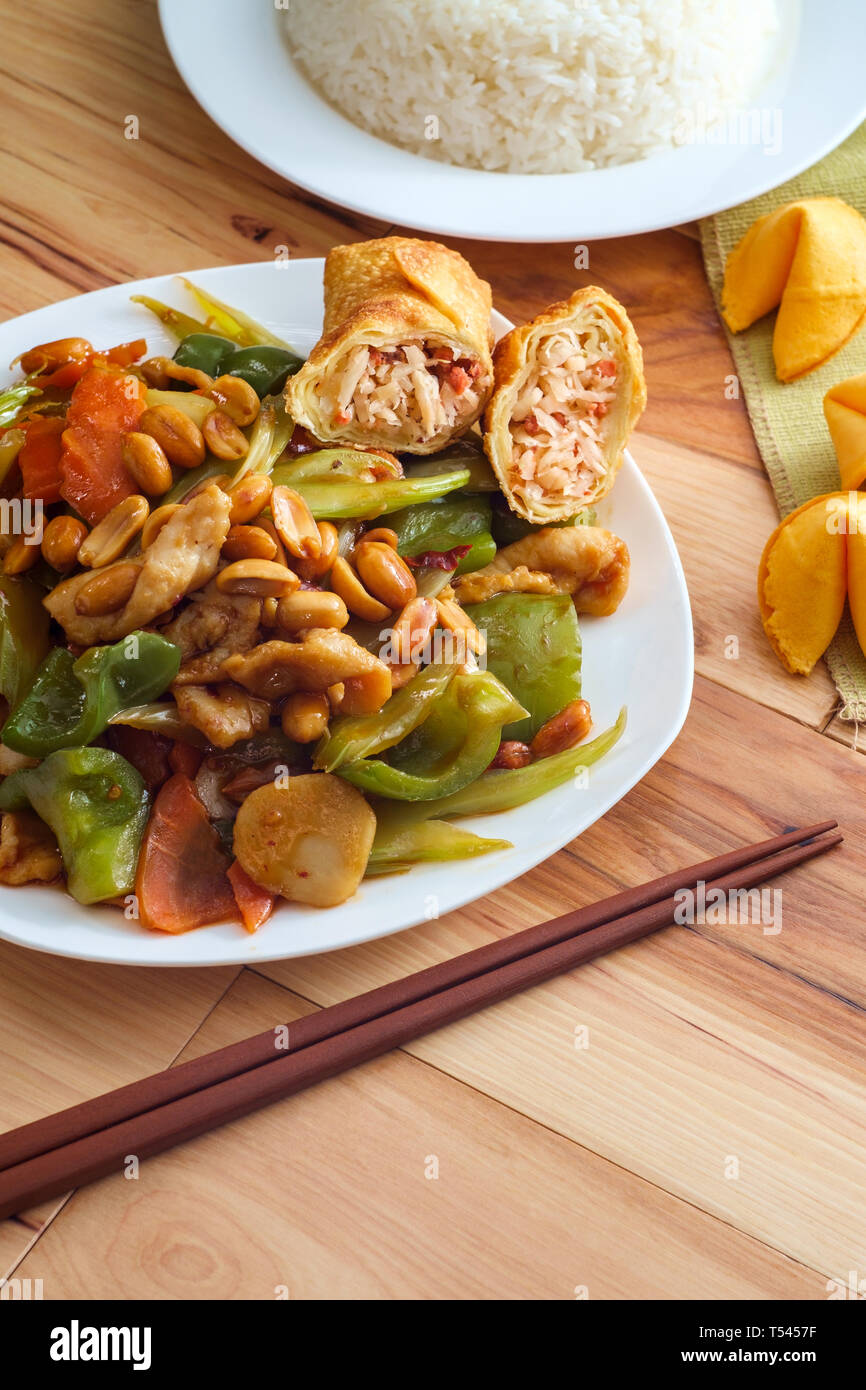Chinese food spicy Kung Pao Chicken with peanuts and egg roll Stock