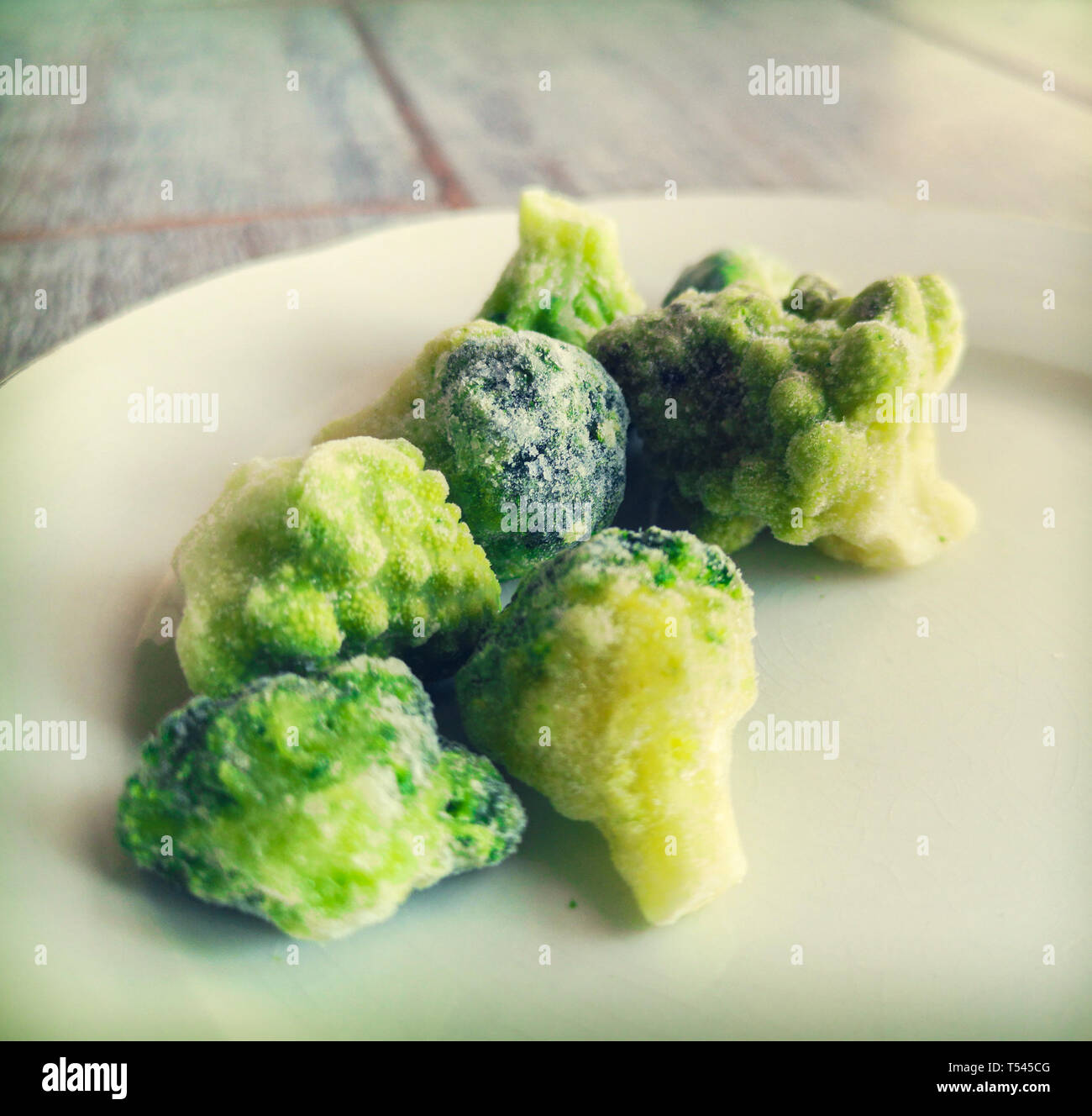 frosted broccoli frozen veggies icing in freezer fridge Stock Photo