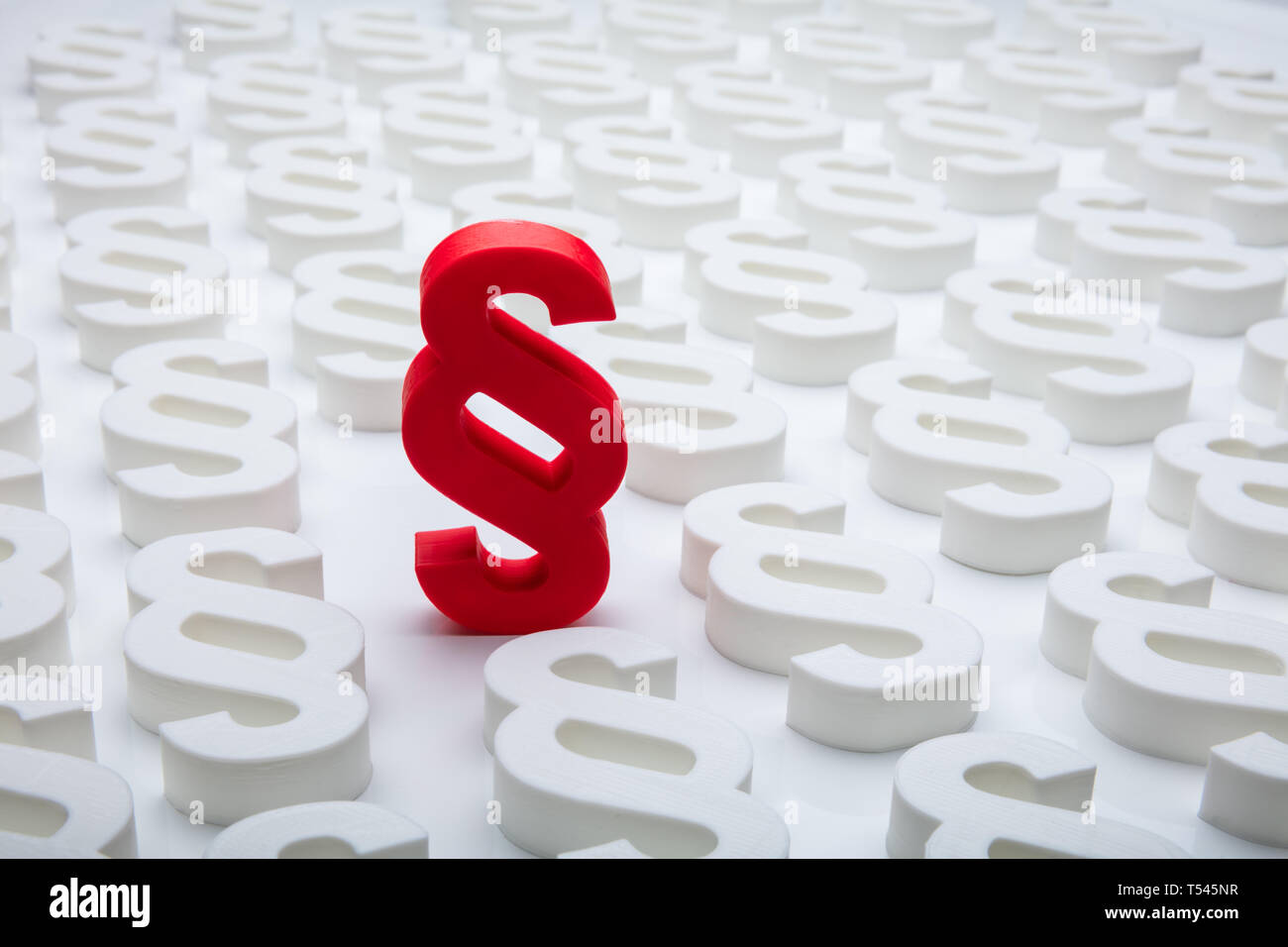 Close-up Of Red Paragraph Symbol Leading Others On White Background Stock Photo