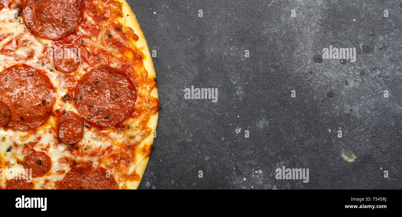 Italian pizza pepperoni on gray stone background Stock Photo - Alamy