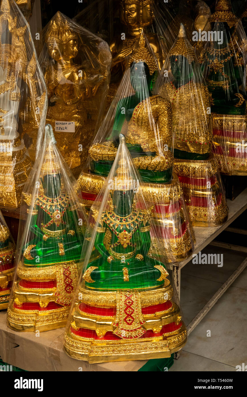 Thailand, Bangkok, Thanon Bamrung Mueang, Buddhist Supplies Shop, green plastic emerald buddhas wrapped in plastic for sale Stock Photo