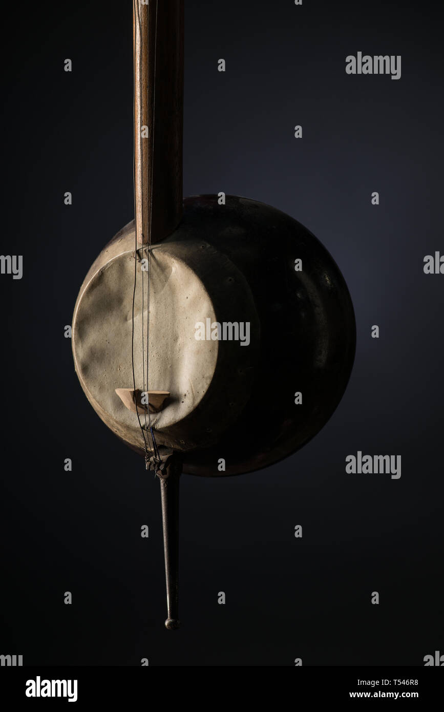 part ancient Asian stringed musical instrument on black background with ...