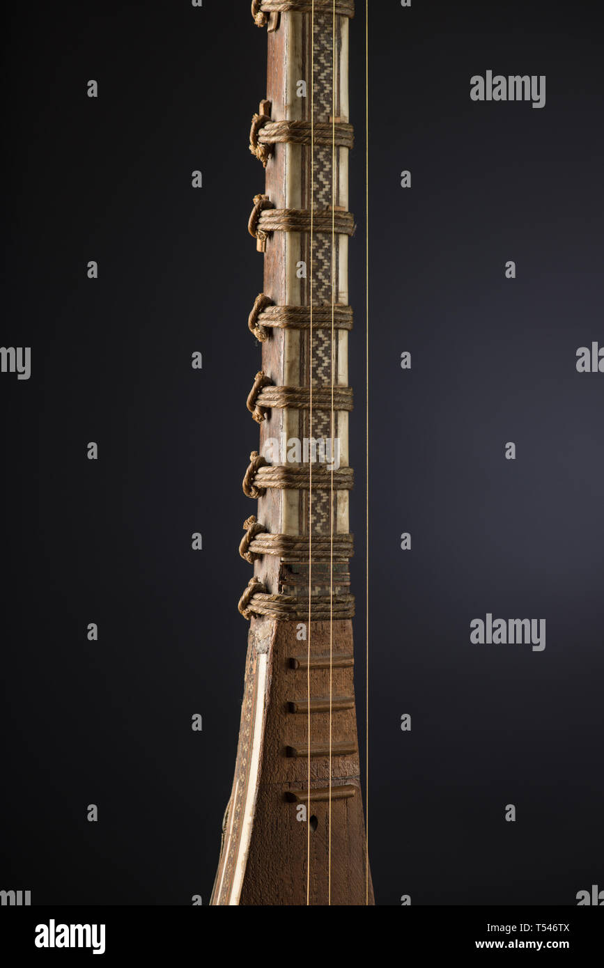 ancient Asian stringed musical instrument on black background with ...